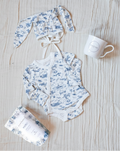 Bundle featuring a blue-and-white toile bodysuit, a matching blue-and-white toile bunny bonnet, Maman coffee, and a Maman hidden bunny mug.