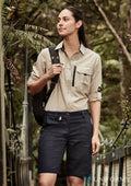 Woman in hiking attire wearing Syzmik Women’s Rugged Cooling Vented Shorts outdoors