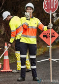 Construction worker holding stop sign wearing Syzmik Ladies BIO Motion Taped Pant ZP720