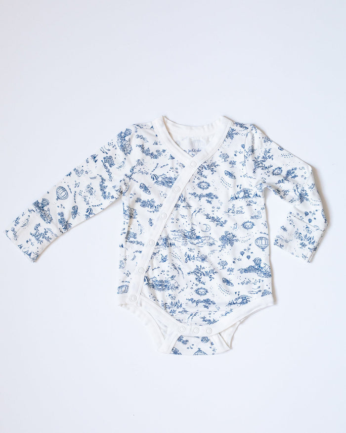 Blue-and-white toile bodysuit with flowers, bunnies, butterflies, hot air balloons, boats, moons, and suns.