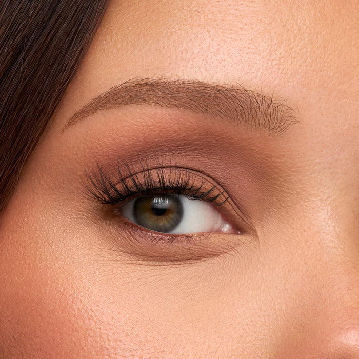 Close-up of an eye with soft brown eyeshadow and long lashes from The Muse Half Lash