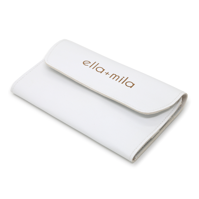 White faux-leather manicure tool case, closed with embossed ella+mila logo