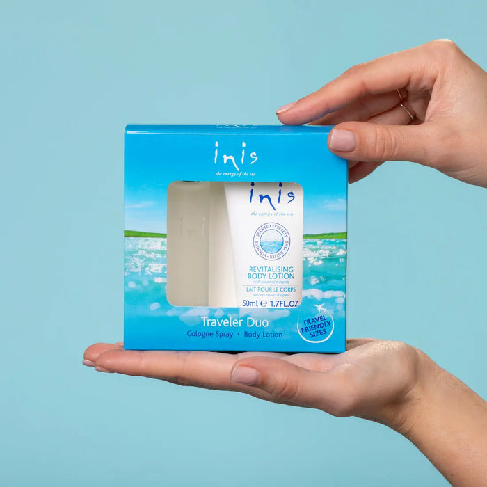 A person holding a blue 'inis' travel set against a light blue background
