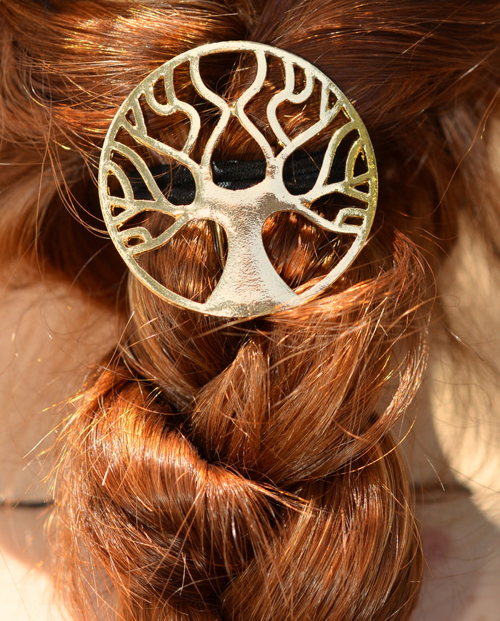 female model wearing the Hair Hook Tree of Life in gold wrapped around her ponytail braid