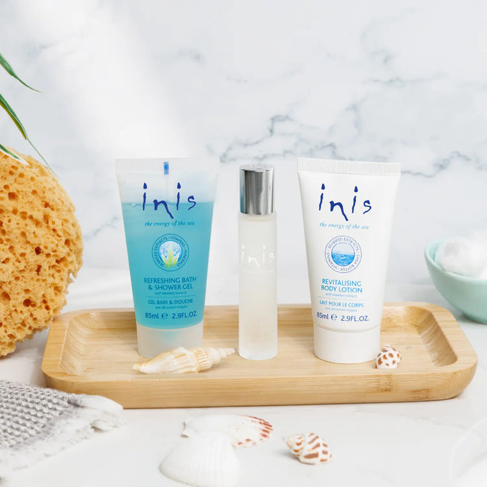 Three inis products on a wooden tray with a marble background