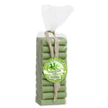 A pack of artisanal verbena-scented guest soaps, wrapped in green cloth and tied with a string, with a label on the front.