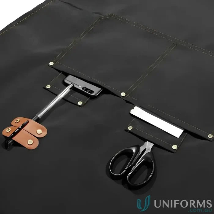 Black waterproof canvas kitchen apron with multiple pockets and tool loops in vibrant colors