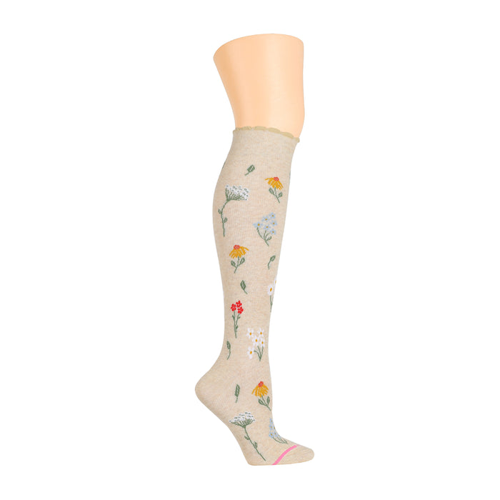 Knee-high compression socks in beige with colorful wildflower patterns.